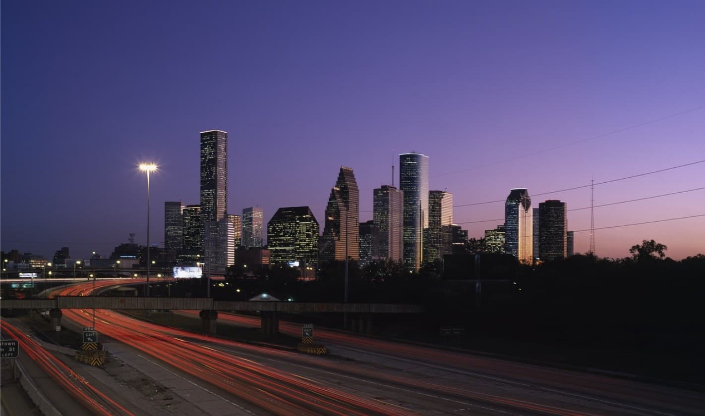 Houston downtown skyline at dusk with highway light trails